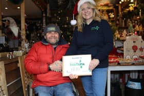 Christmas tree farmer Clive Collins with Bexhill Foodbank representative Jenni Barnes