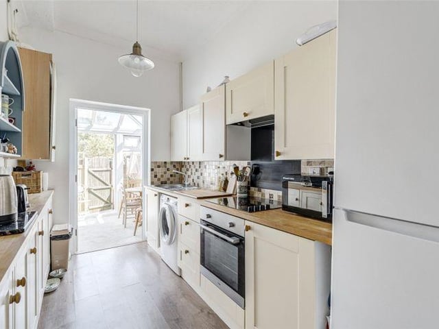 The kitchen has modern units with an integrated oven and hob