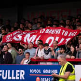 Crawley Town fans with their 'WAGMIOUT' banner at the games against MK Dons at the Broadfield Stadium on Tuesday night. Picture: Eva Gilbert