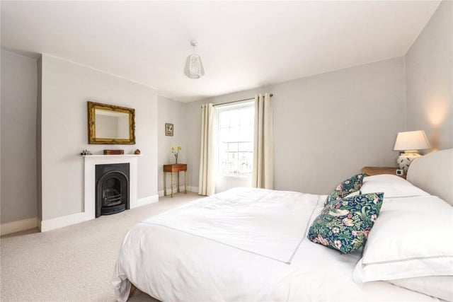 The property has three bedrooms with sash windows and original fireplaces.