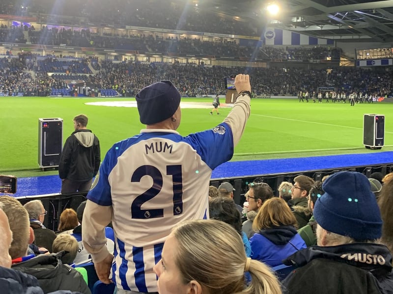 One supporter getting a shot of the atmosphere at the Amex Stadium.