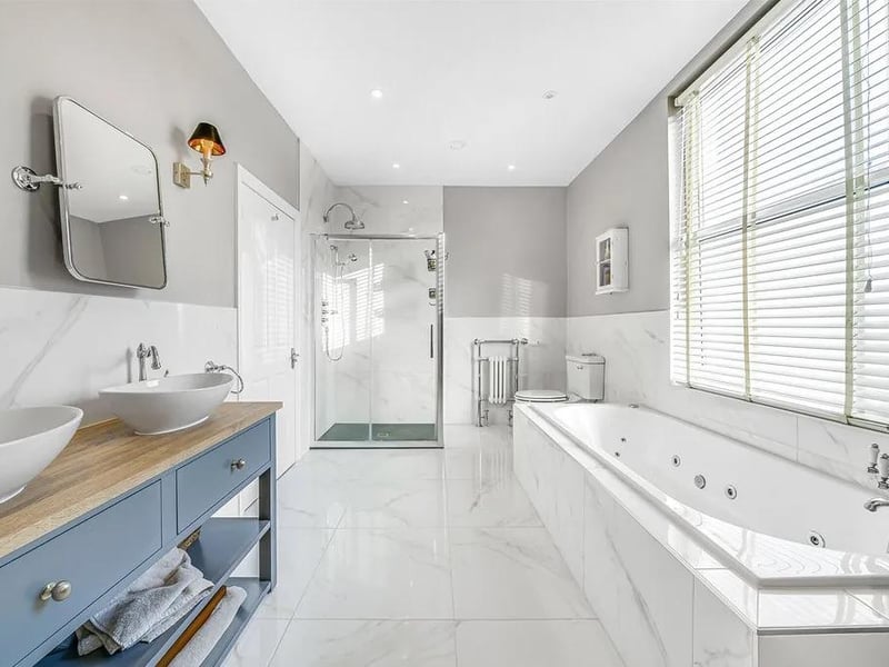 The master bedroom's en-suite bathroom features a 'his and hers' vanity with sinks, a Whirlpool Jacuzzi Bath and a separate shower cubicle