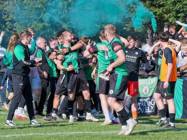Burgess Hill Town players, fans and staff celebrate surviving in the Isthmian south east division at the end of their 0-0 draw with Beckenham