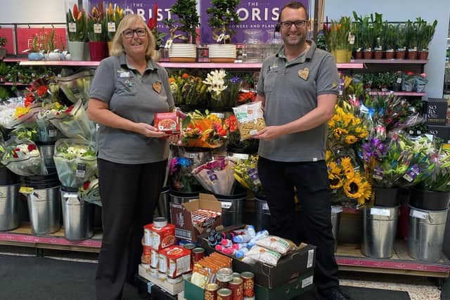 Alison Whitburn, community champion for the Littlehampton store, and colleague Darren sorting food to give away to community projects