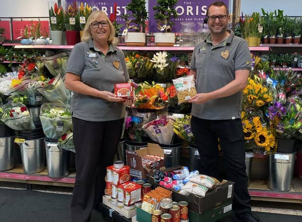 Alison Whitburn, community champion for the Littlehampton store, and colleague Darren sorting food to give away to community projects