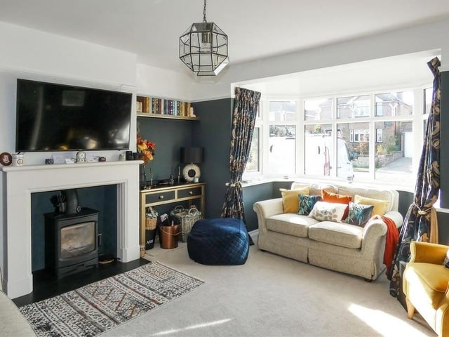 The west-facing lounge has a wood burning stove and deep bay window