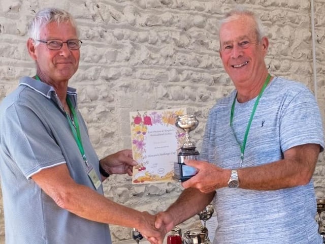 Show secretary Simon Smith receives the Howard Challenge Cup for the gentleman winning most points in all classes from chairman Chris Hill