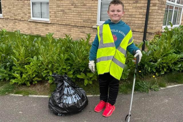 James Bravery, 7, wearing his special litter-picking gloves with his rubbish-grabbing stick