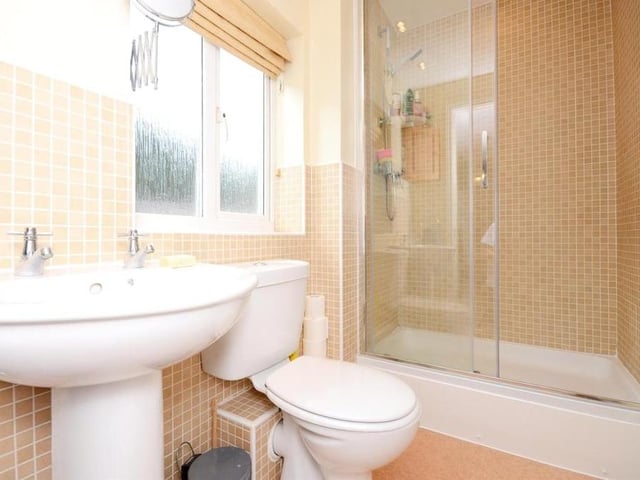 Two of the bedrooms boast en suite shower rooms. Here is one of them, with a shower cubicle, wash hand basin and low-flush WC.