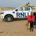Camber Sands RNLI Lifeguard with rescued puppy. Picture: RNLI/Georgia Mockridge
