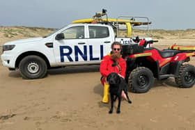 Camber Sands RNLI Lifeguard with rescued puppy. Picture: RNLI/Georgia Mockridge