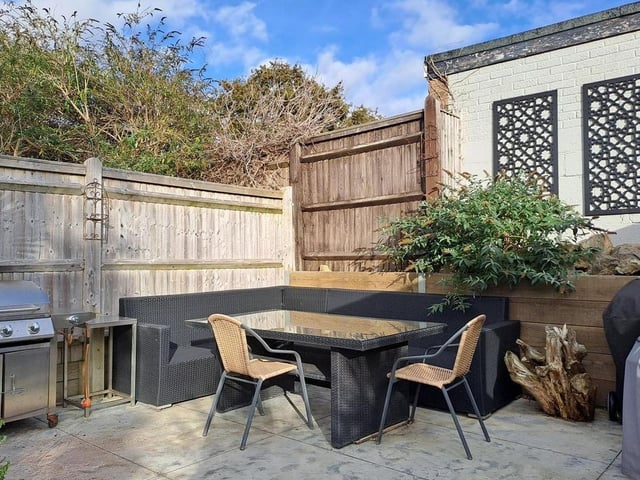 The raised patio at the end of the garden