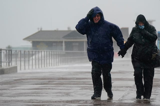 People brave the weather as they make their way along the seafront in Southsea as Storm Barra hit. Picture: Andrew Matthews/PA Wire