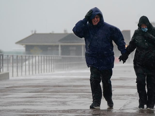 People brave the weather as they make their way along the seafront in Southsea as Storm Barra hit. Picture: Andrew Matthews/PA Wire