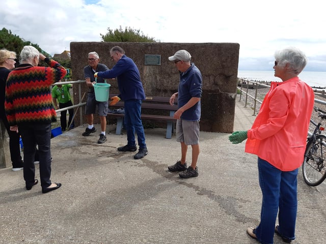 A bucket chain of volunteers from Ferring History Group and Ferring Conservation Group, including Worthing West MP Sir Peter Bottomley, form a bucket chain to bail out nine inches of water from the Ferring pillbox