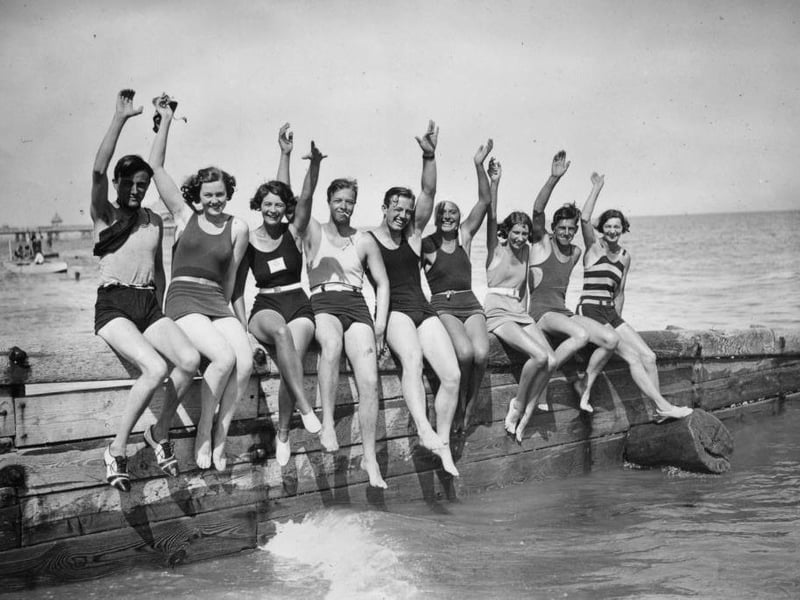 A group of tourists on the breakwater in Eastbourne.