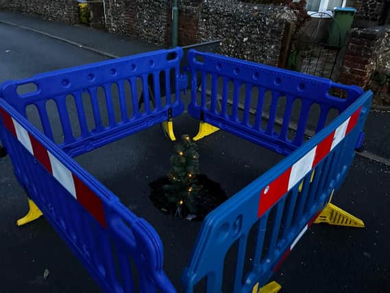Soon after it appeared, cheeky residents decorated the sink hole with a Christmas tree.