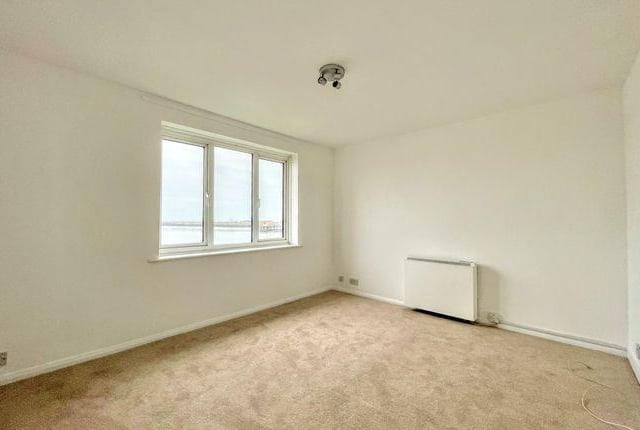 The living room is south facing, with a window to the front with sea view and an electric heater.