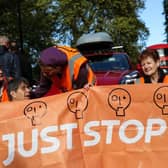 Members of the environmental activist group Just Stop Oil hold a banner as they block Park Lane, in central London, on Sunday | Picture: Getty