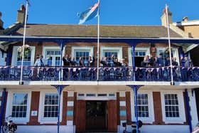 Chairman Ann Hewings and Commodore Michael Mansergh, Deputy Lieutenant for West Sussex, left, with members on the balcony of the 381 Club