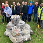 Some of the litterpickers and the haul of rubbish collected from local roads and lanes, with event coordinator Roy Wilkinson (front centre).  