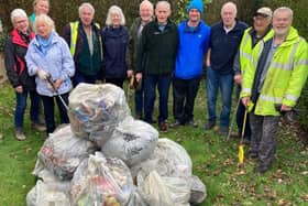 Some of the litterpickers and the haul of rubbish collected from local roads and lanes, with event coordinator Roy Wilkinson (front centre).  