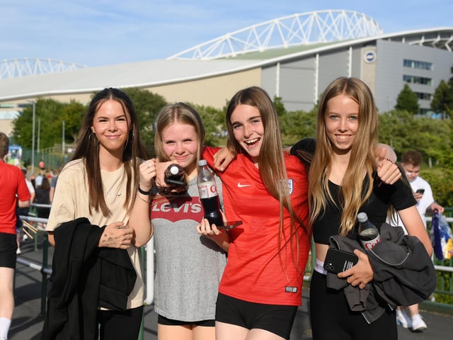 England fans pose for a photo outside the stadium.