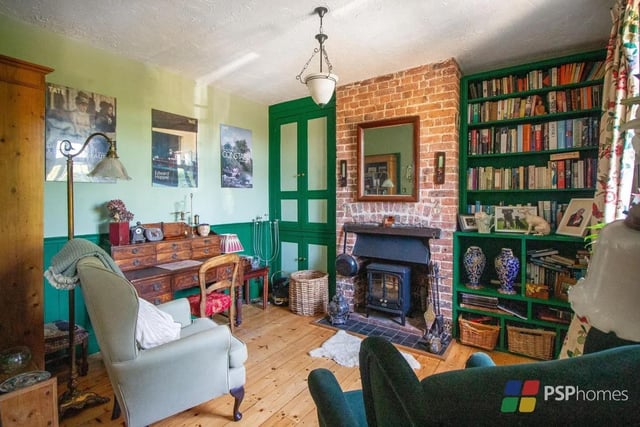 The dining/family room has an open fire, exposed brickwork and exposed floorboards