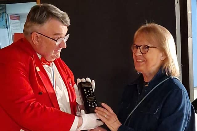 Master of Ceremonies Bob Smytherman presents the Outstanding Contribution to Worthing Award to Ginny Cassell, head of Worthing charity Storm
