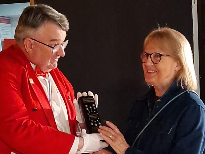 Master of Ceremonies Bob Smytherman presents the Outstanding Contribution to Worthing Award to Ginny Cassell, head of Worthing charity Storm