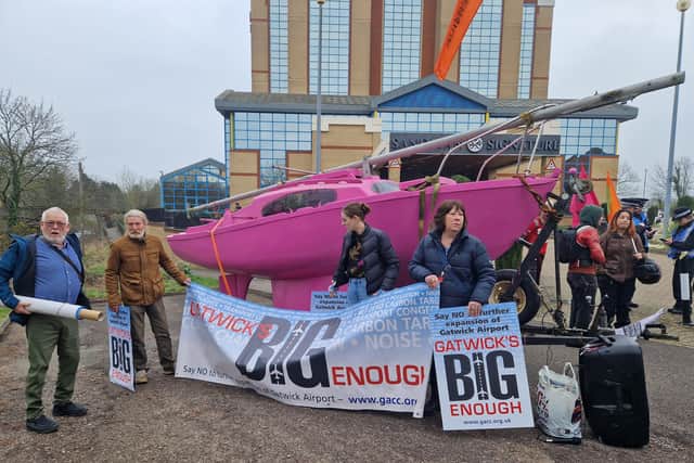 The climate and environment activists have moored the iconic XR Pink Boat in front of the venue with banners reading 'Fewer Flights Not More' and 'Flying To Extinction' and are accompanied by drummers from XR Rhythms. Another banner reading 'Flight Reductions Not Airport Expansion' is stretched across the dual carriageway outside. Picture: Mark Dunford