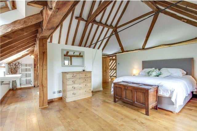 The principal bedroom has a dressing area, en suite bathroom, and wonderful views to the Downs