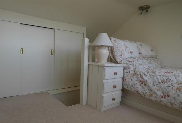 The second-floor bedroom with storage cupboards