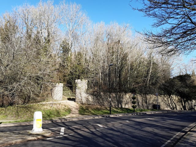 Cross The Street and head up the road in between the turrets. Be aware this is the entrance to the English Heritage car park.