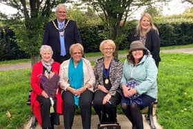 Haywards Heath town mayor Howard Mundin and Mid Sussex MP Mims Davies with Haywards Heath Town Councillor Sandy Ellis and members of the Mid Sussex Branch
of Parkinson’s UK on the new seat in the sensory garden at Beech Hurst