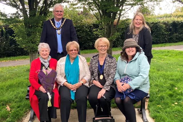Haywards Heath town mayor Howard Mundin and Mid Sussex MP Mims Davies with Haywards Heath Town Councillor Sandy Ellis and members of the Mid Sussex Branch
of Parkinson’s UK on the new seat in the sensory garden at Beech Hurst