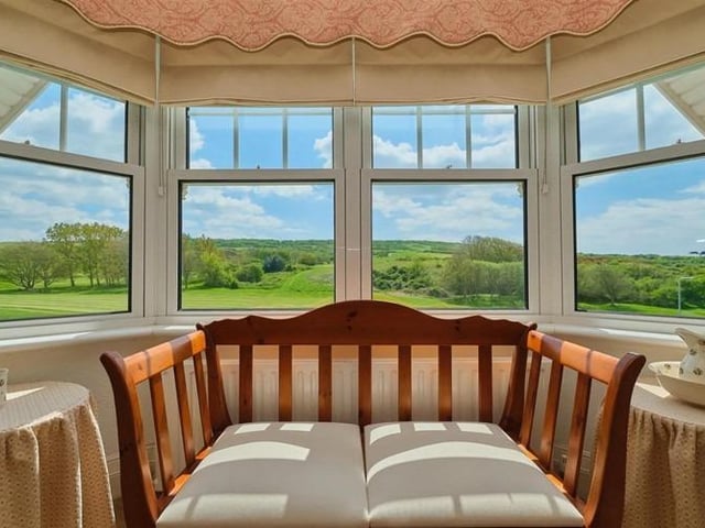 Bay windows with seating to take advantage of the infinity garden view