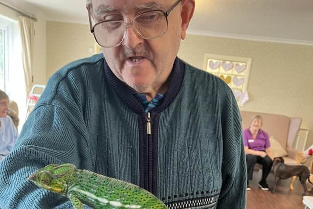 A resident from Mountside Care Home with Pascal the Chameleon.