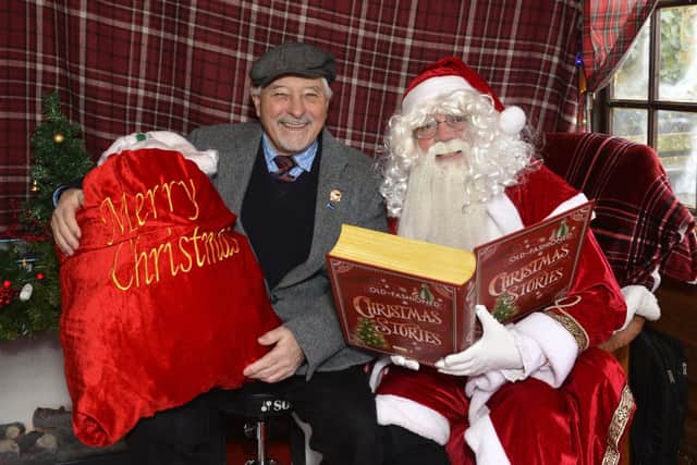 Councillor Chris Mullins with Santa in his grotto