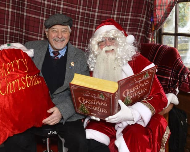 Councillor Chris Mullins with Santa in his grotto