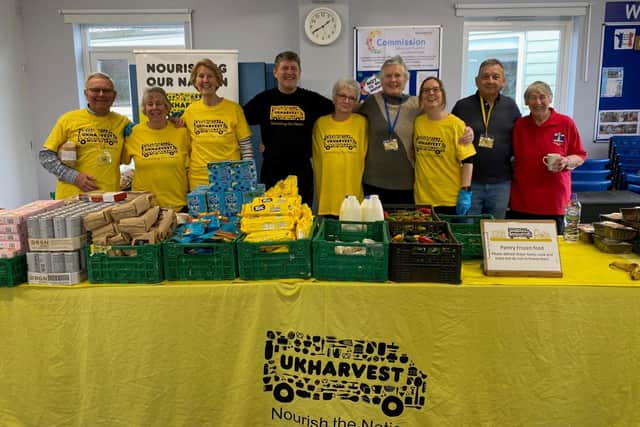 A team of UK Harvest volunteers, including Nigel in a black t-shirt, at one of their 16 community food hubs around West Sussex