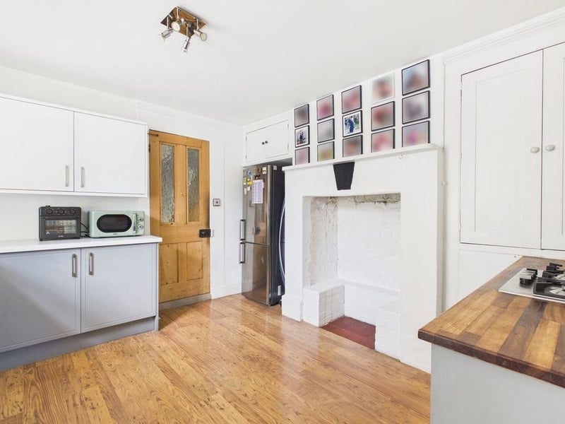 There are ample work surfaces and integrated appliances, including a gas hob, double oven and dishwasher