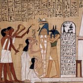 Priests performing rituals in front of a mummy - from The Book Of The Dead
