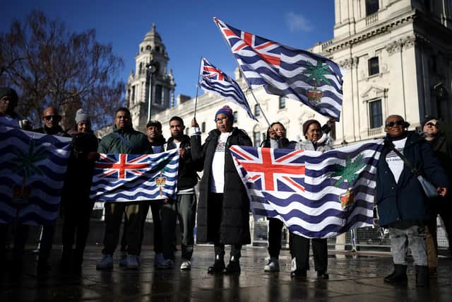 Supporters and members of the British Indian Ocean territory Chagos Archipelago hold placards and the territory's flag outside the Houses of Parliament in London on January 7, 2026, to protest against a proposed plan by the British government to hand over the islands to Mauritius. Picture by Henry Nicholls/AFP via Getty Images