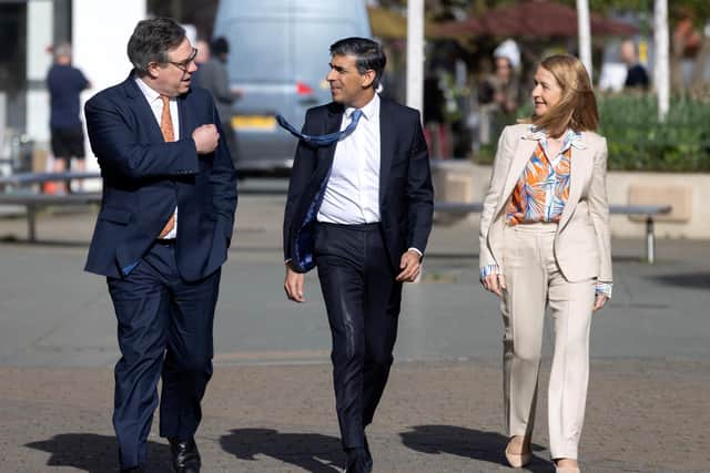 Prime Minister Rishi Sunak speaks with Conservative MP Jeremy Quinn (L) and Sussex Police and Crime Commissioner Katy Bourne (R) during a visit in Horsham, West Sussex, on April 10, 2024. (Photo by RICHARD POHLE/POOL/AFP via Getty Images)