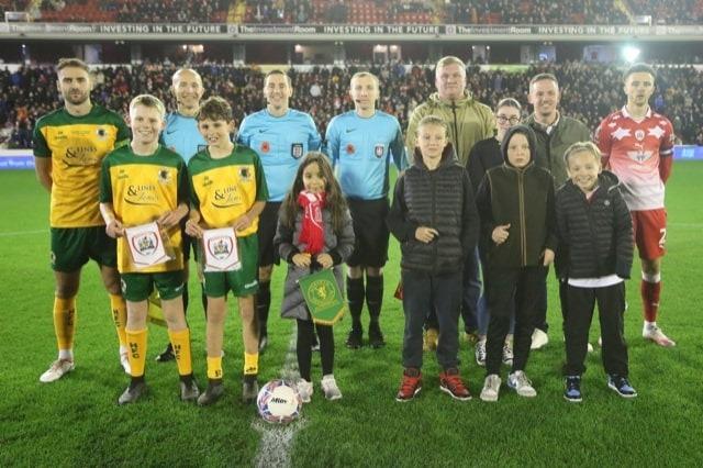 Finley and Bobby line-up with Horsham captain Jack Brivio ahead of Friday evening's FA Cup clash with Barnsley