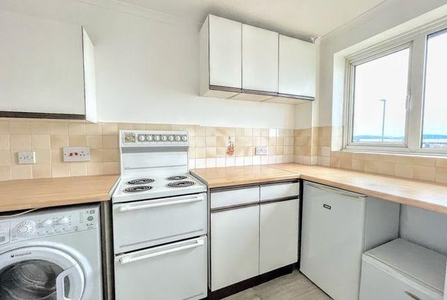 The kitchen also has a window to the front with sea view.