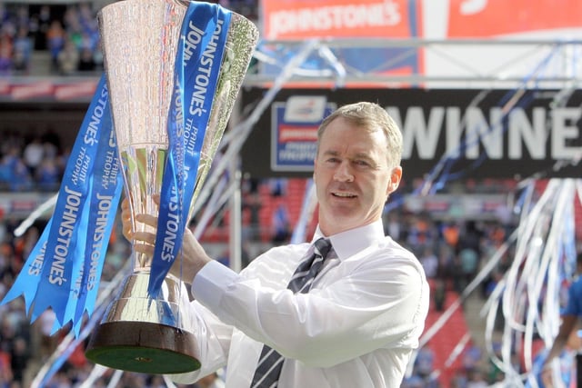 Spireites boss John Sheridan lifts the trophy after masterminding a magical victory for the club.