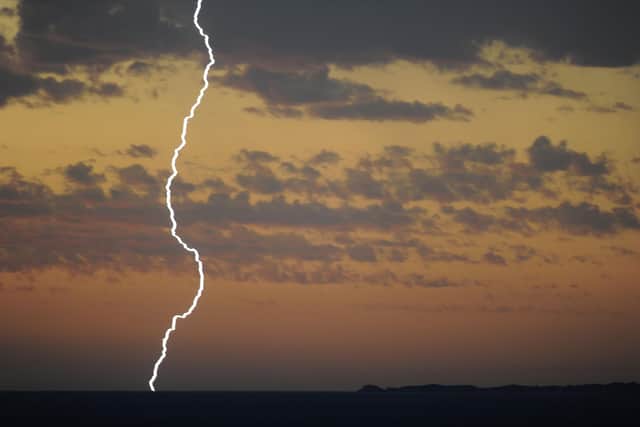 The Met Office said there will 'probably' be 'some damage to a few buildings and structures from lightning strikes'. (Photo by GREG WOOD/AFP via Getty Images)