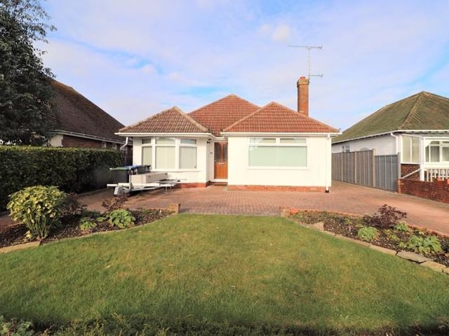 This three-bed, detached bungalow in Wadhurst Drive, Goring, has a guide price of £600,000. Outside there is parking for several vehicles and a garage with workshop.